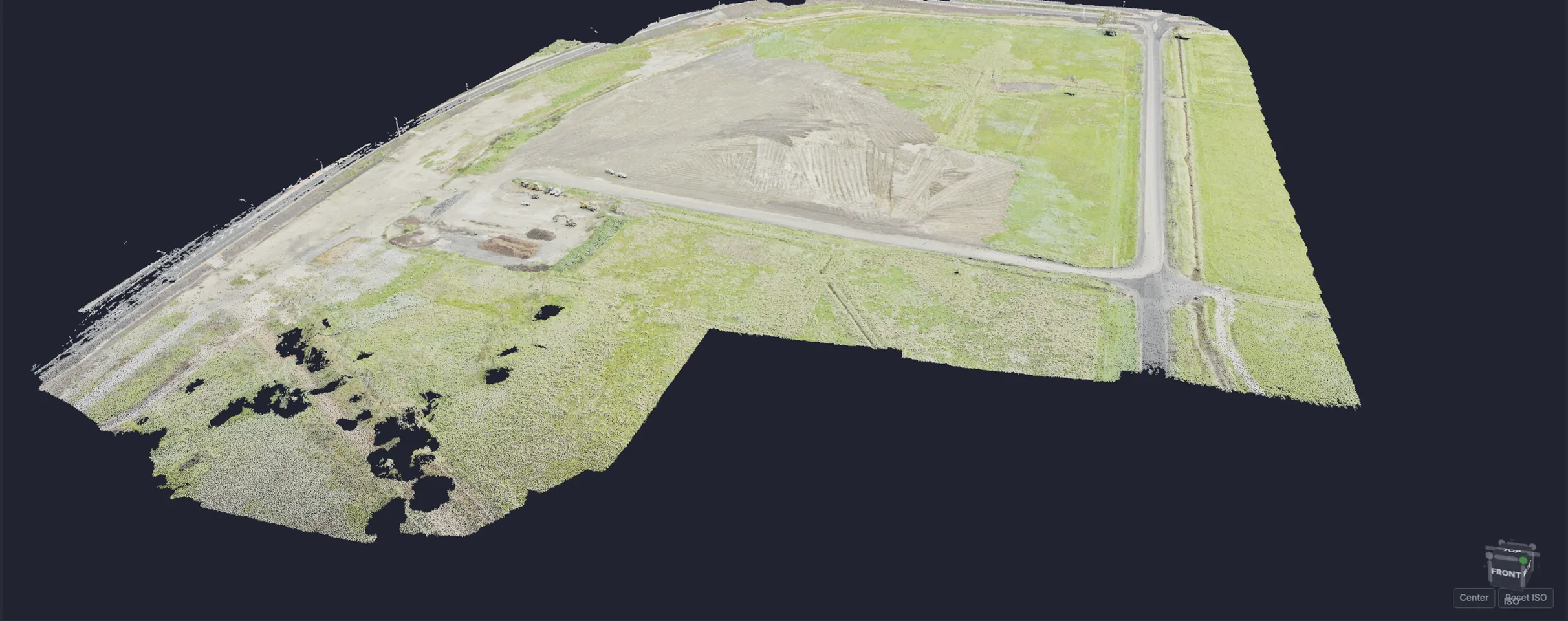 A drone survey of a construction laydown area rendered as a 3D point cloud in PrimeCad, showing a stripped pad, stockpile and haul roads